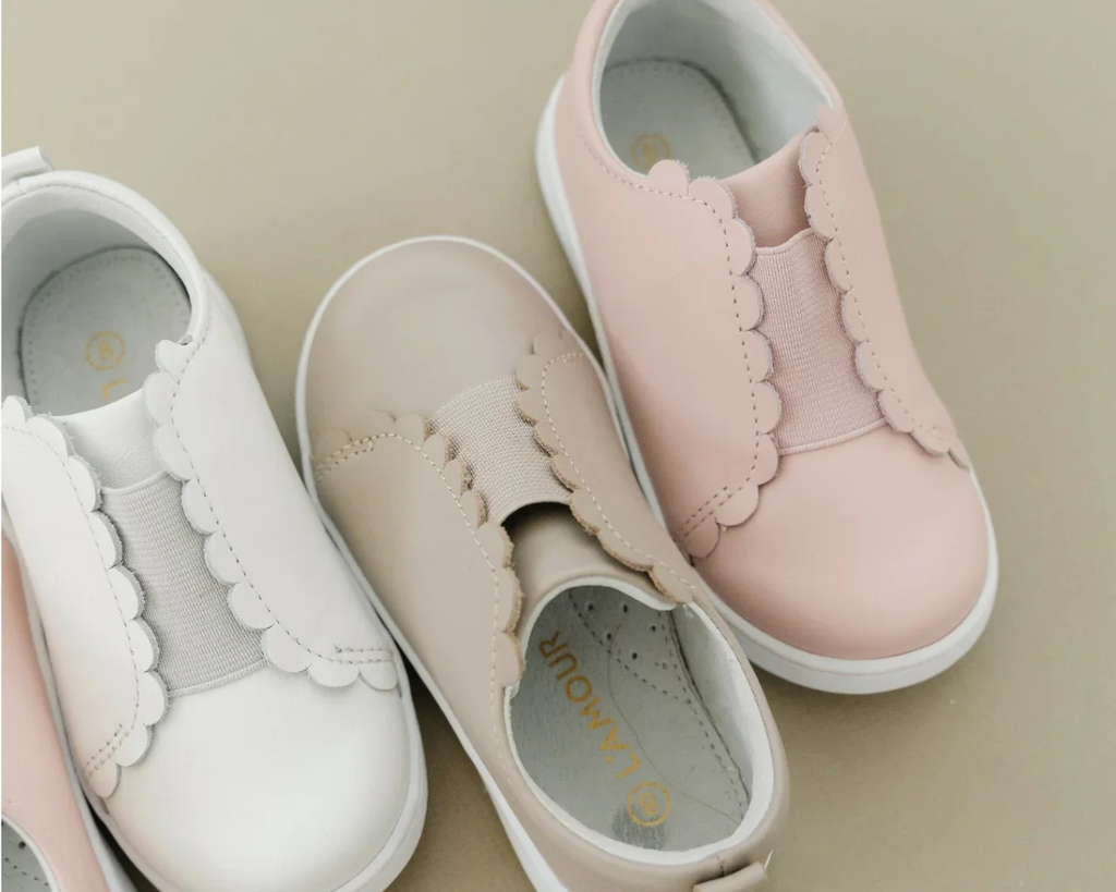 Flat lay of L’amour Scalloped Sneakers 682 in pink, beige, and white.